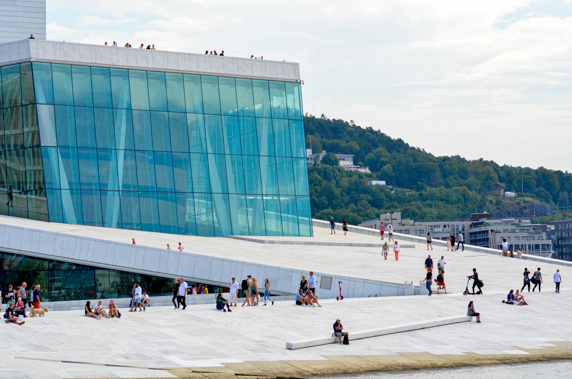 Oslo Opera Binasının çatısında yürüyen ve dinlenen insanlar
